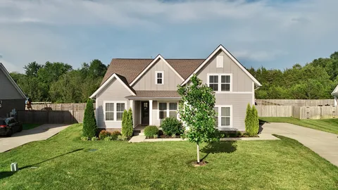 a view of a house with backyard and a garden