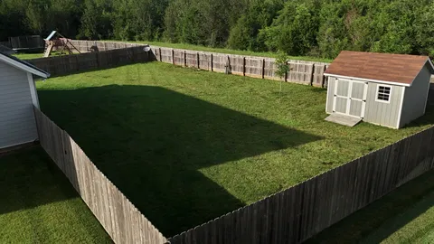 a view of a wooden deck and a yard