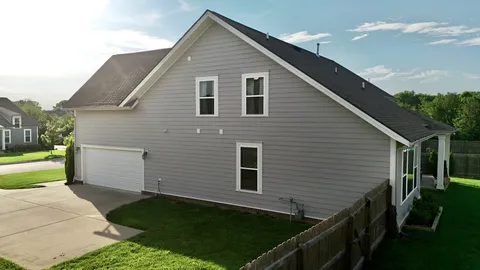 a view of house with backyard and garden