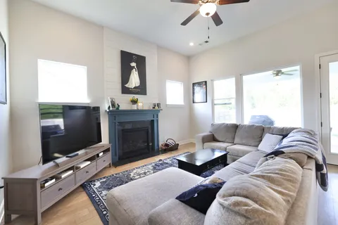 a living room with furniture a flat screen tv and a fireplace