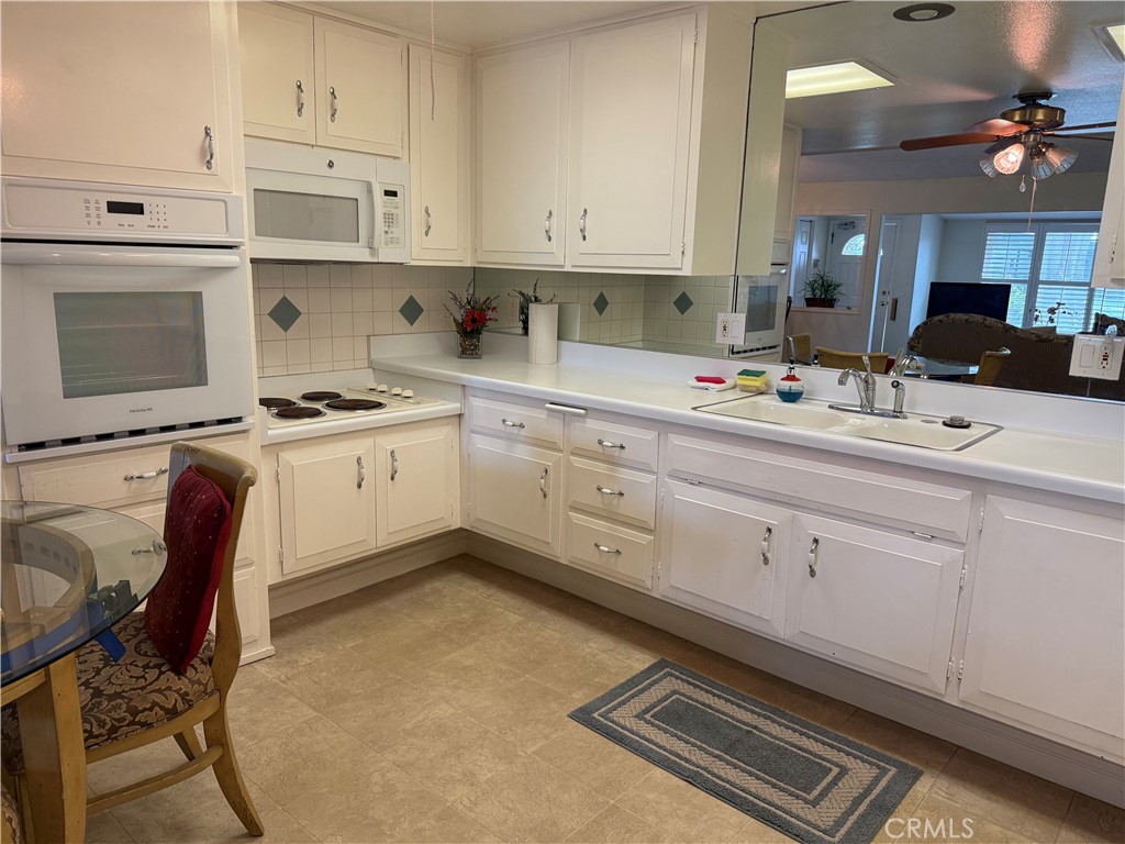 1441 Homewood Road Seal Beach, CA 90740 - Photo 12 of 25 a kitchen with a stove window and cabinets