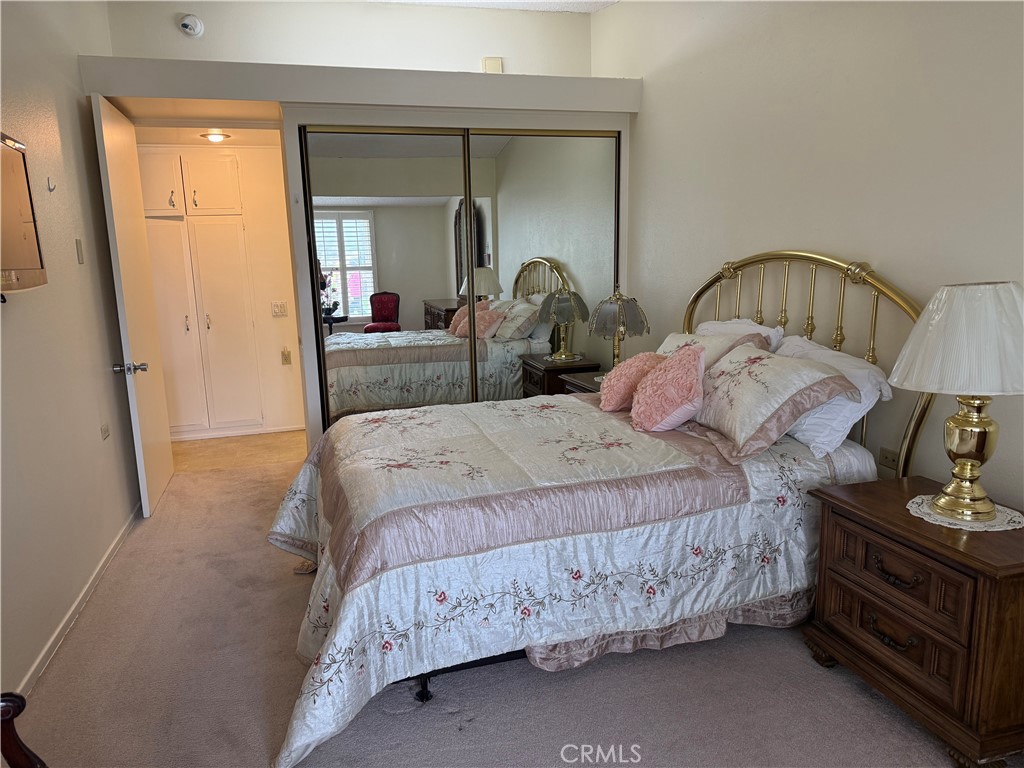 1441 Homewood Road Seal Beach, CA 90740 - Photo 15 of 25 a bedroom with a bed and a mirror