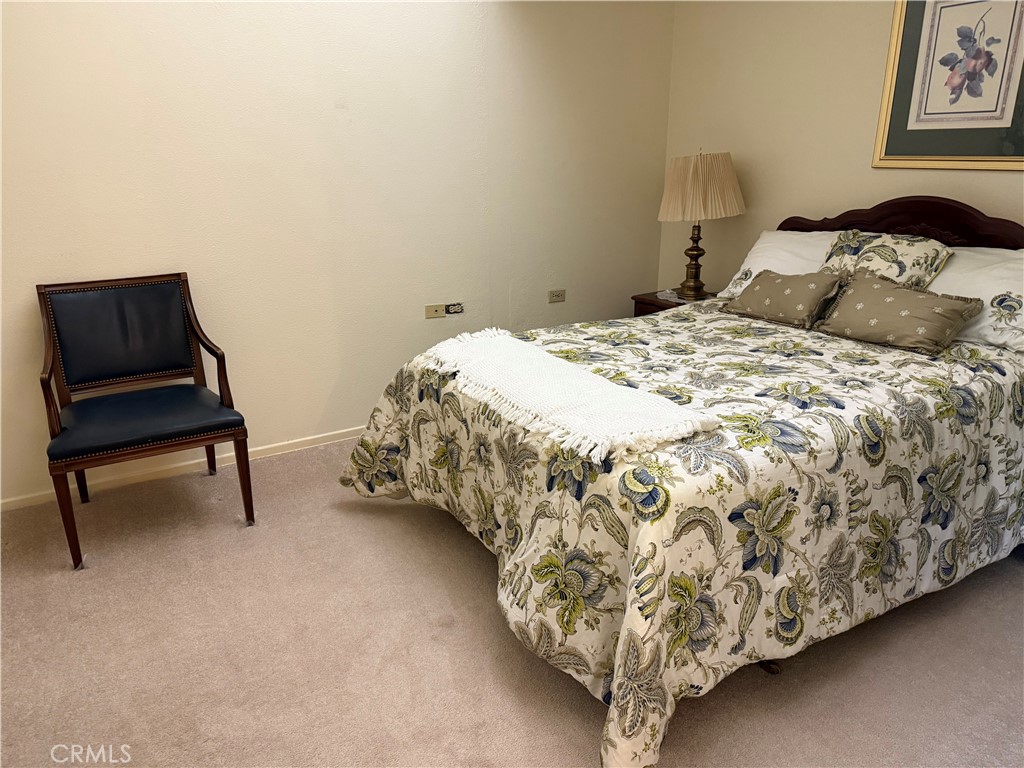 1441 Homewood Road Seal Beach, CA 90740 - Photo 22 of 25 a bedroom with a bed and a chair