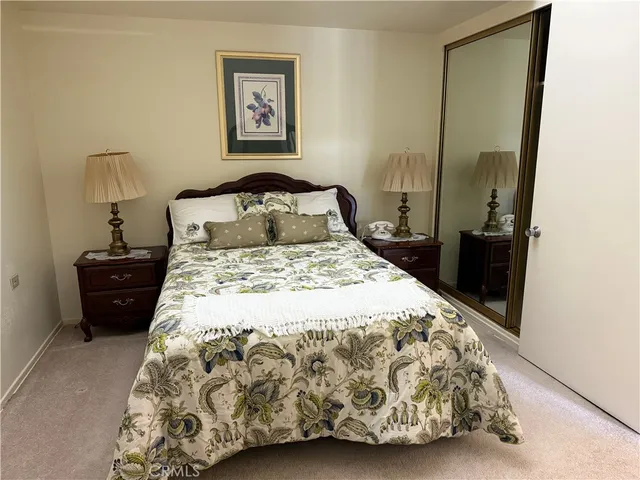 a bedroom with a bed and a mirror