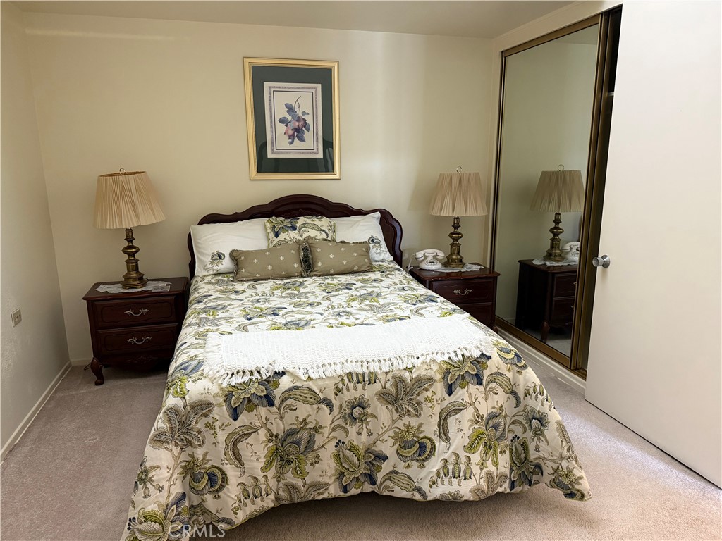 1441 Homewood Road Seal Beach, CA 90740 - Photo 23 of 25 a bedroom with a bed and a mirror