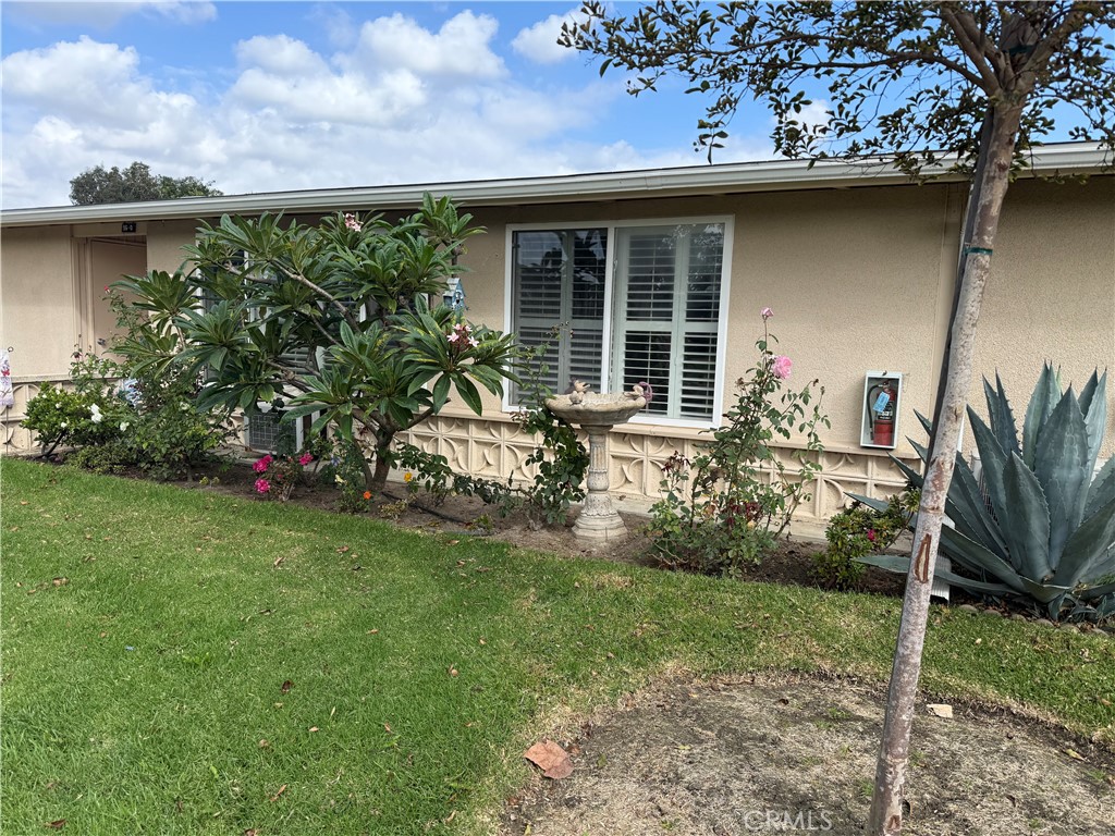 1441 Homewood Road Seal Beach, CA 90740 - Photo 24 of 25 a front view of a house with garden