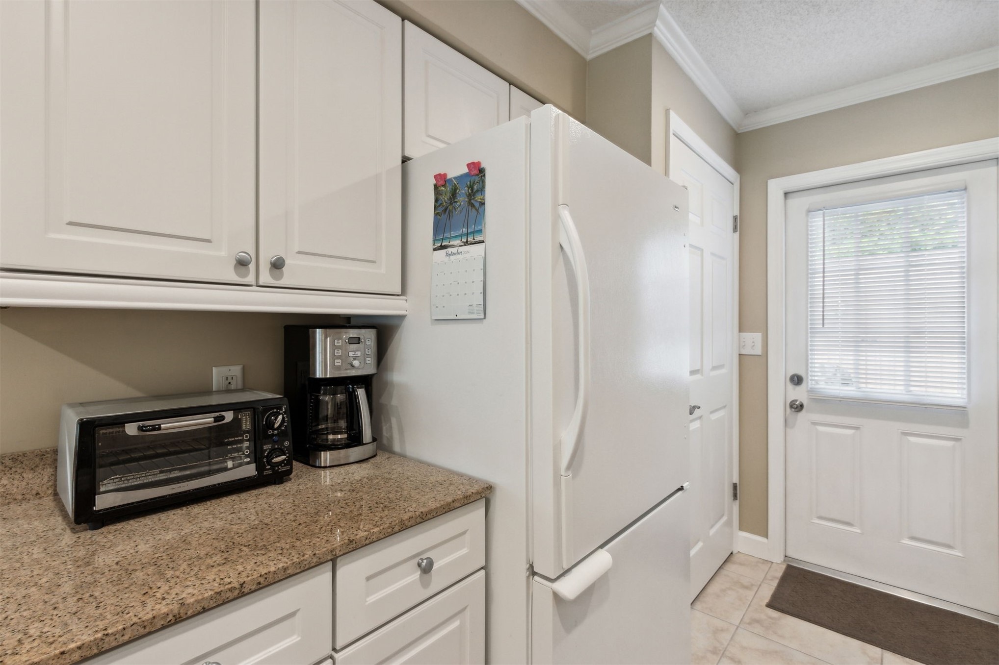 3327 Sea Marsh Road, Unit 3327 Fernandina Beach, FL 32034 - Photo 6 of 39 a kitchen with granite countertop a refrigerator and a sink