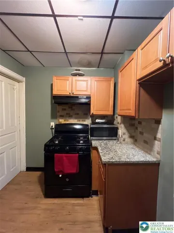 a kitchen with a stove sink and microwave