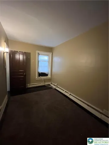 an empty room with a empty space and windows
