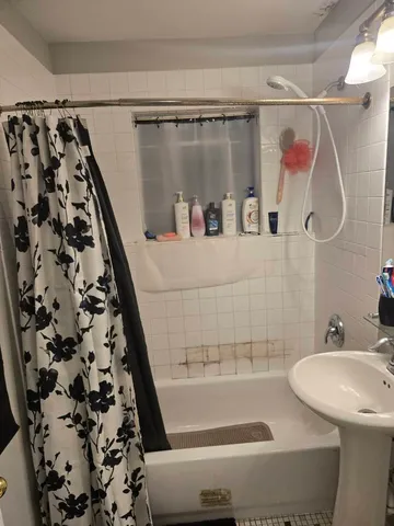 a bathroom with a bathtub and shower
