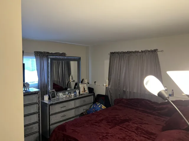 a bed room with a bed and a window