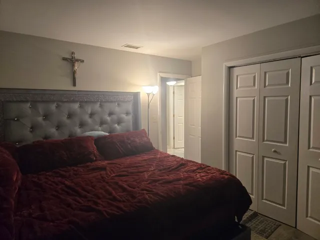 a bedroom with a bed and a window