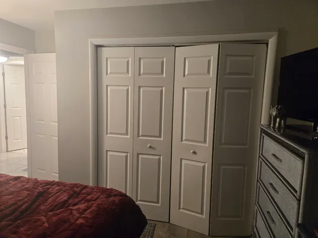 a bedroom with a bed and a flat tv screen