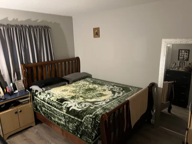 a bed sitting in a bedroom next to a window