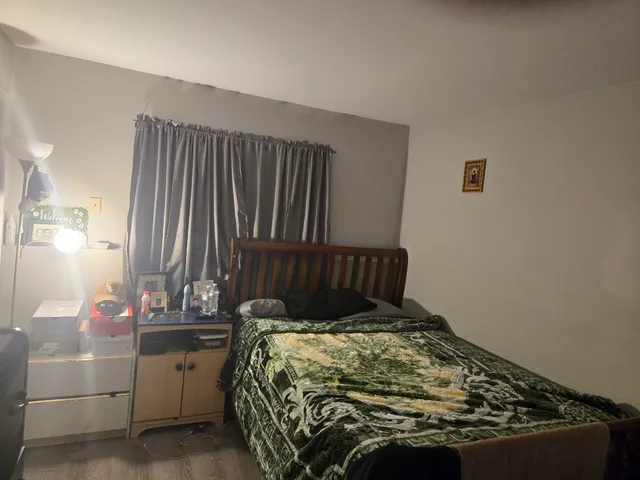 a bed sitting in a bedroom next to a window