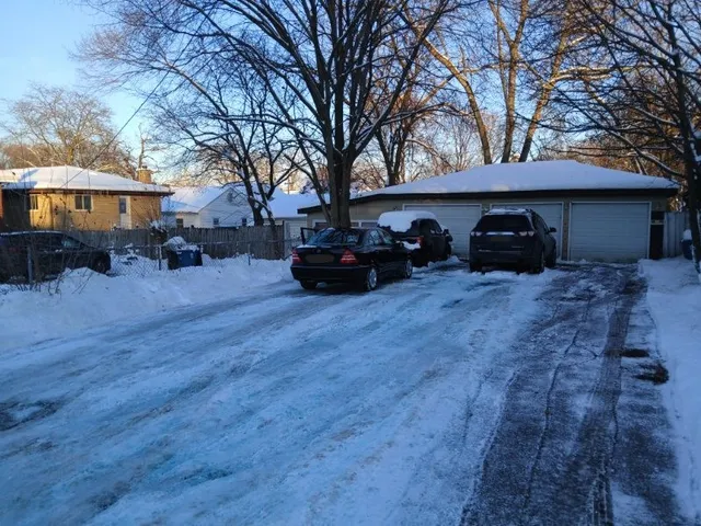 a view of a house with a yard covered in snow