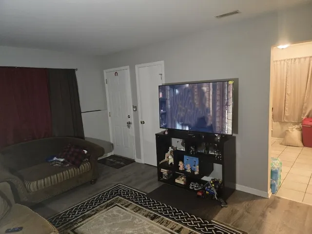 a living room with furniture and a rug