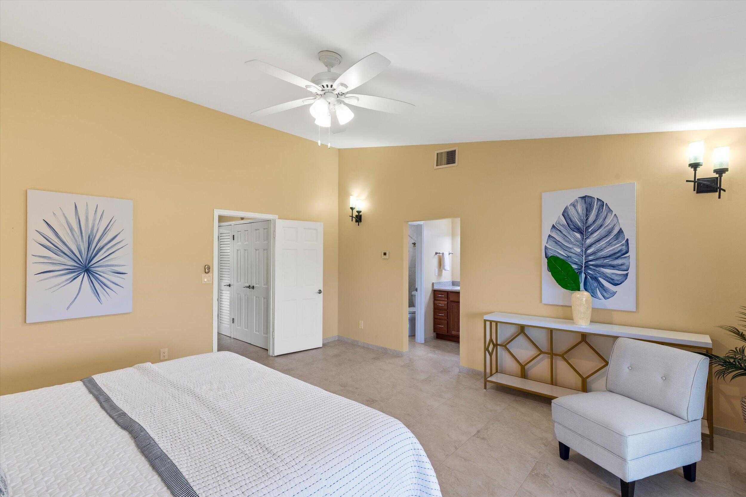 1616 Atlantic Boulevard, Unit 13 Key West, FL 33040 - Photo 16 of 38 a bedroom with a bed and a chandelier