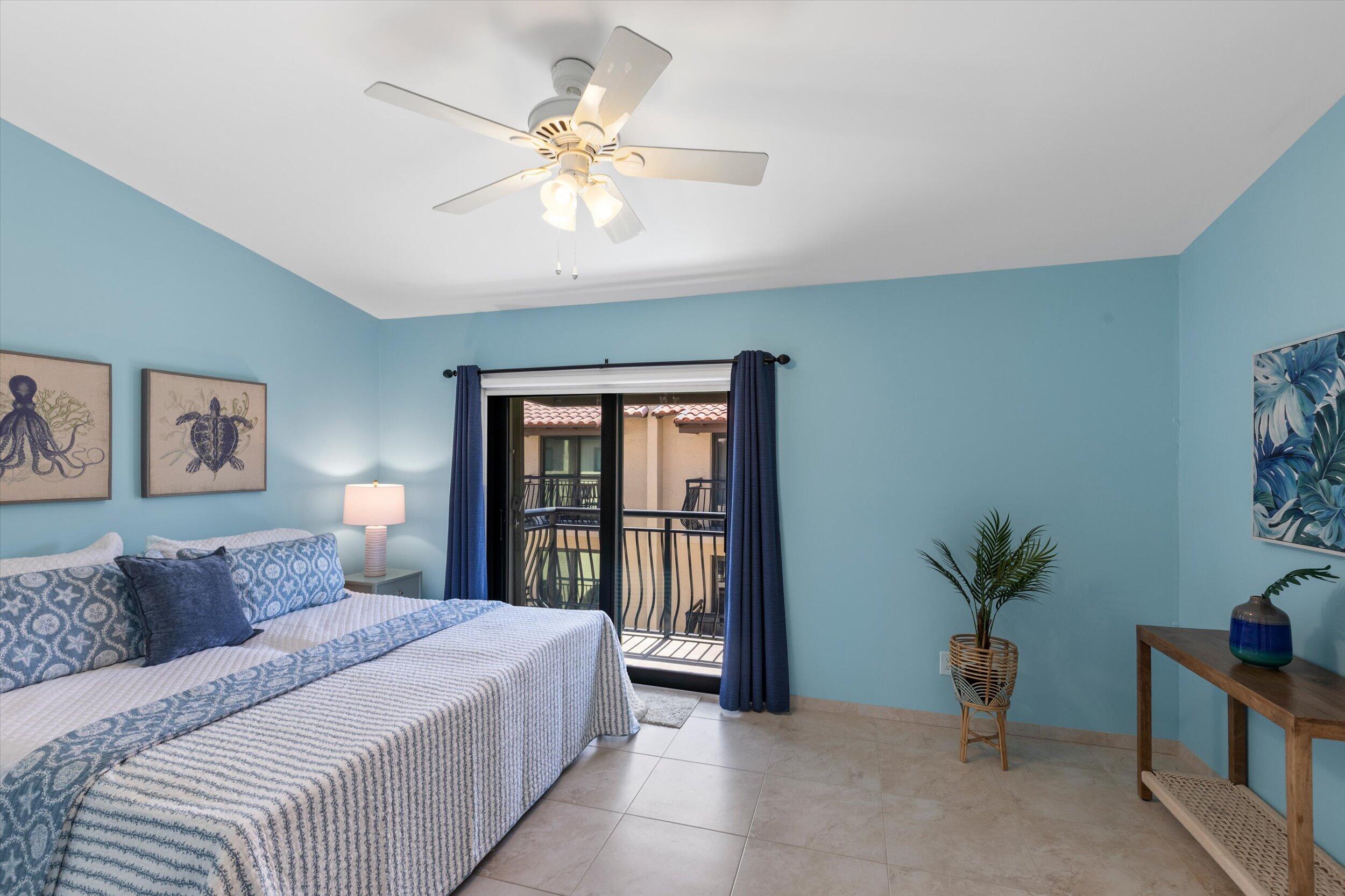 1616 Atlantic Boulevard, Unit 13 Key West, FL 33040 - Photo 18 of 38 a bedroom with a large bed and a chandelier