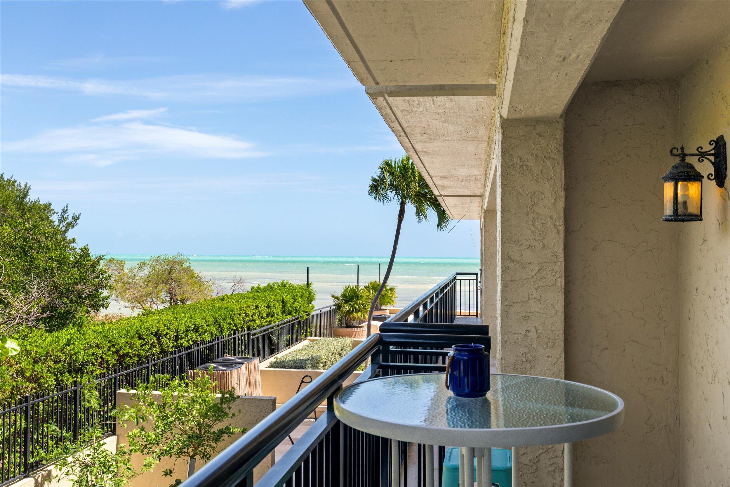 1616 Atlantic Boulevard, Unit 13 Key West, FL 33040 - Photo 19 of 38 a table with chairs and a lake view
