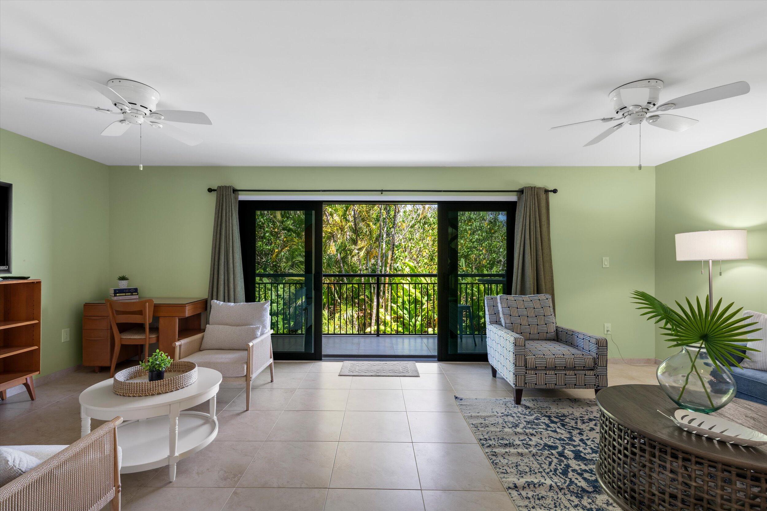 1616 Atlantic Boulevard, Unit 13 Key West, FL 33040 - Photo 20 of 38 a living room with furniture and a large window