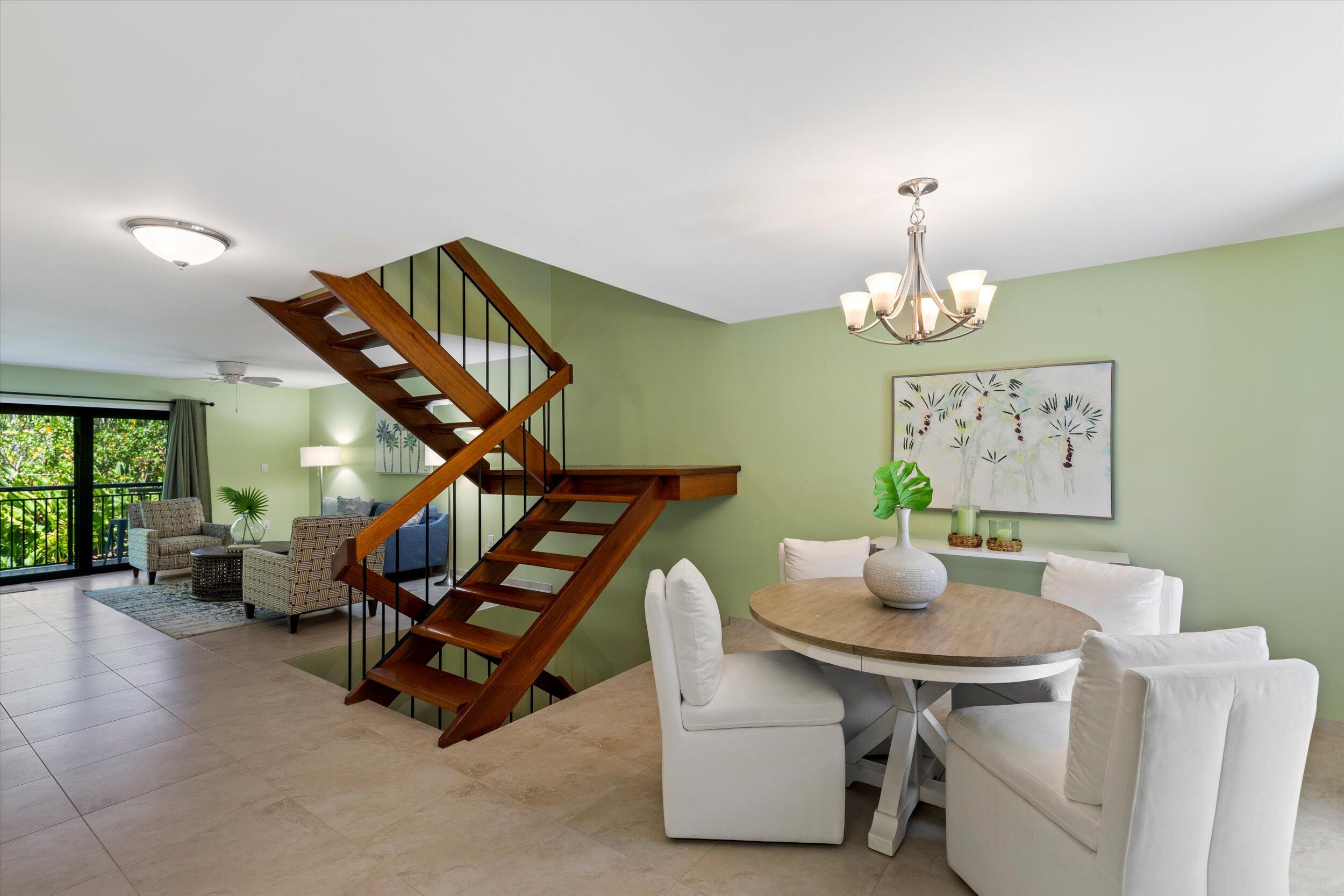 1616 Atlantic Boulevard, Unit 13 Key West, FL 33040 - Photo 22 of 38 a living room with furniture and a chandelier
