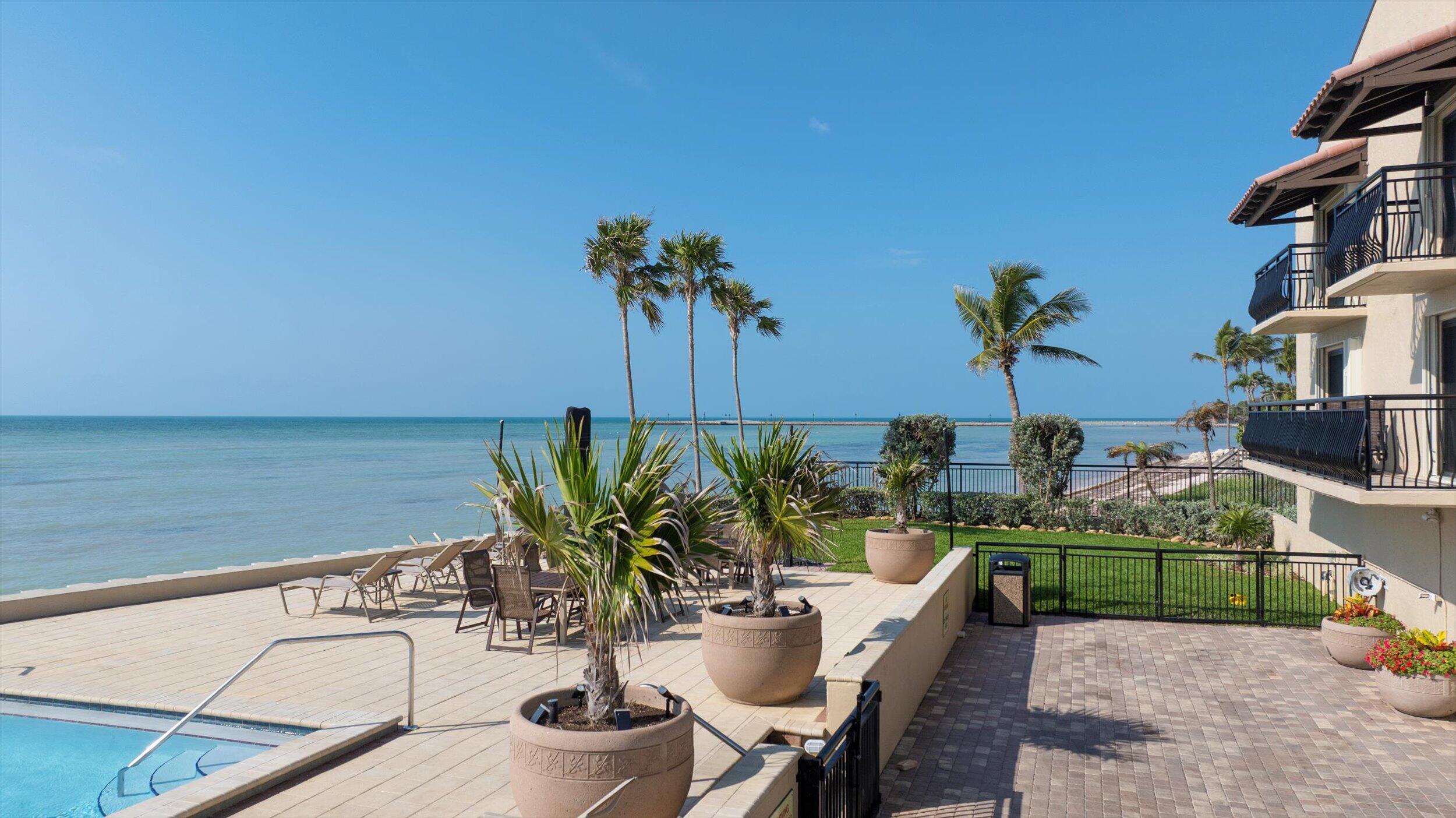 1616 Atlantic Boulevard, Unit 13 Key West, FL 33040 - Photo 30 of 38 a terrace with a table and chairs