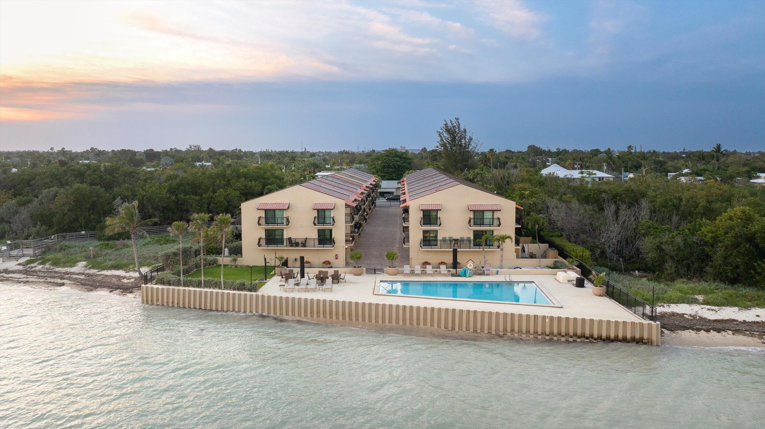 1616 Atlantic Boulevard, Unit 13 Key West, FL 33040 - Photo 3 of 38 a view of a house with a yard and sitting area