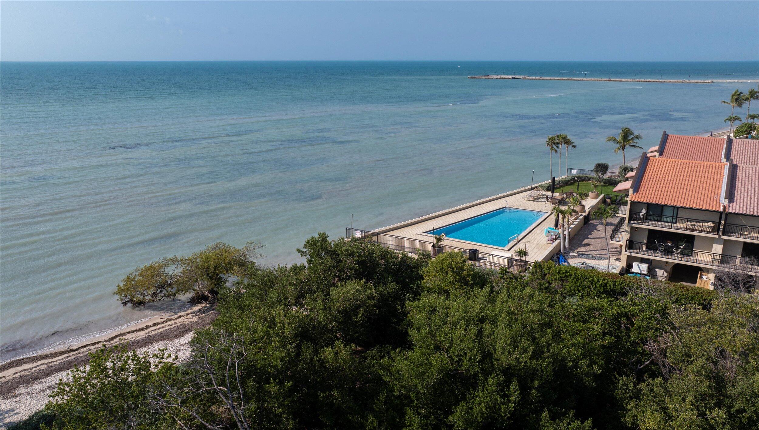 1616 Atlantic Boulevard, Unit 13 Key West, FL 33040 - Photo 33 of 38 a backyard of a house with lots of green space and lake view