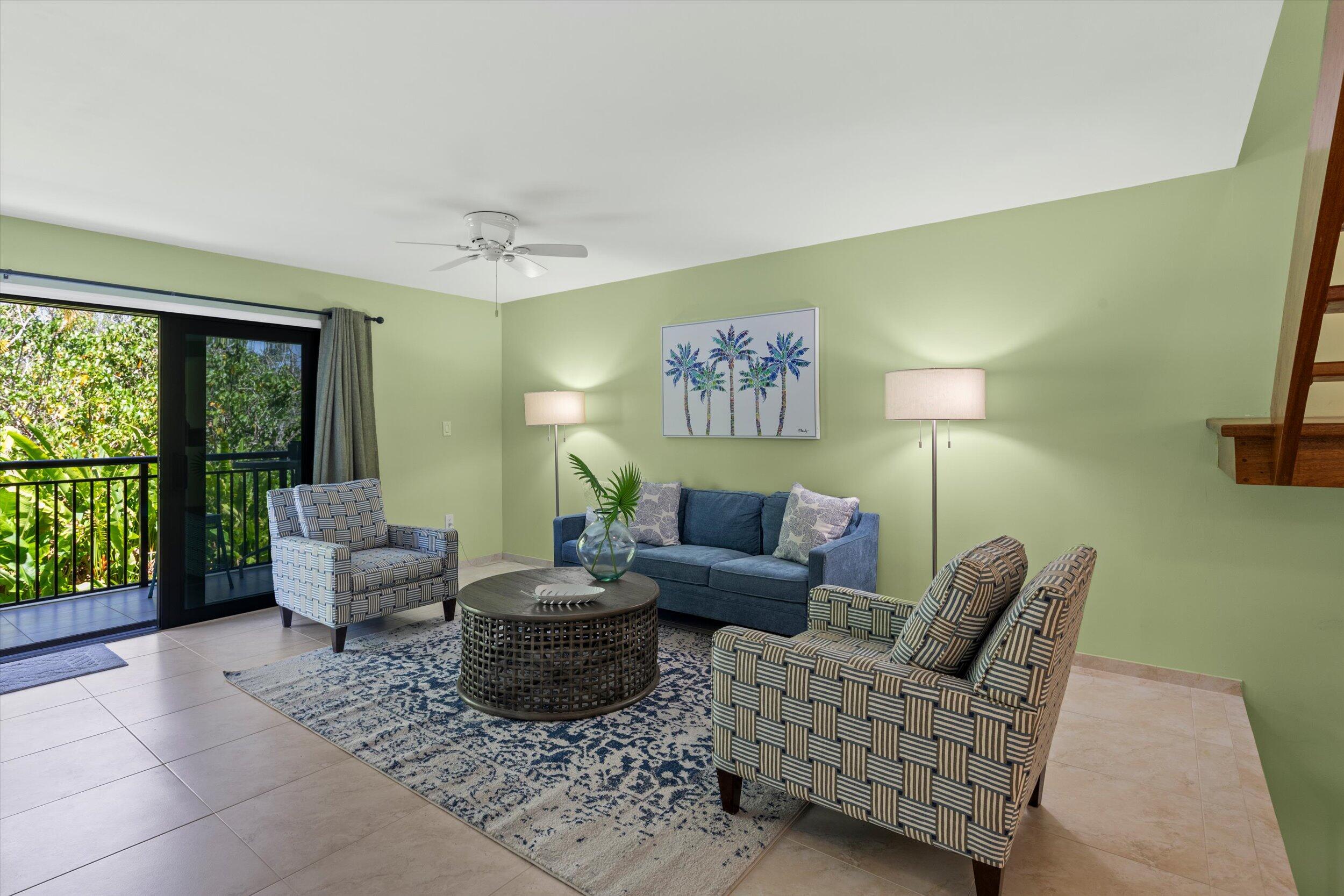 1616 Atlantic Boulevard, Unit 13 Key West, FL 33040 - Photo 5 of 38 a living room with furniture and a floor to ceiling window