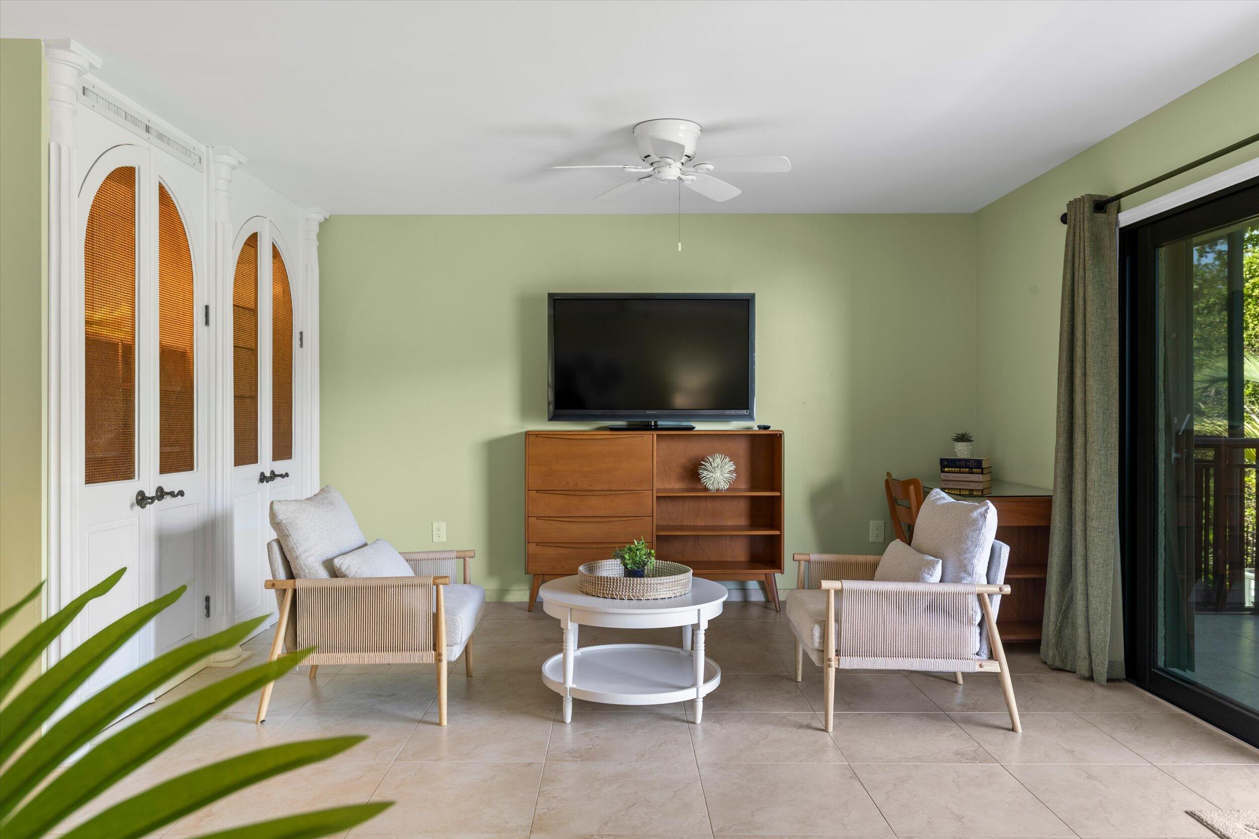 1616 Atlantic Boulevard, Unit 13 Key West, FL 33040 - Photo 7 of 38 a living room with furniture and a flat screen tv