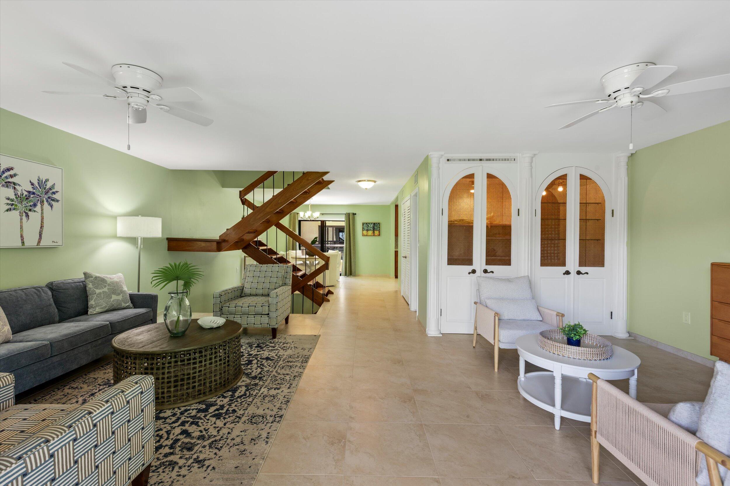 1616 Atlantic Boulevard, Unit 13 Key West, FL 33040 - Photo 8 of 38 a living room with fireplace furniture and a chandelier