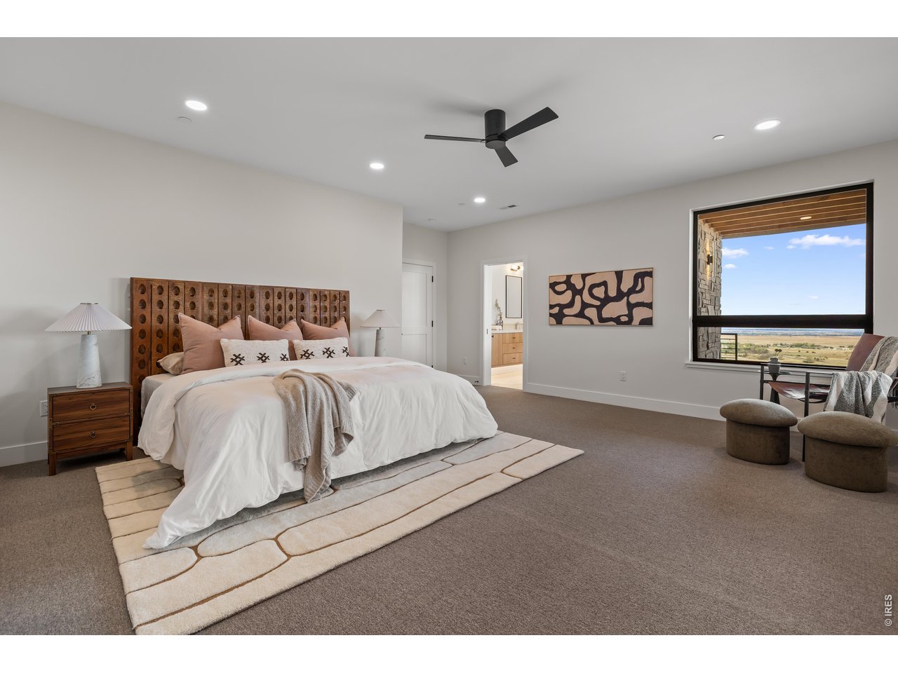 9578 Mountain Ridge Drive Boulder, CO 80302 - Photo 36 of 47 a bedroom with a bed and a flat screen tv