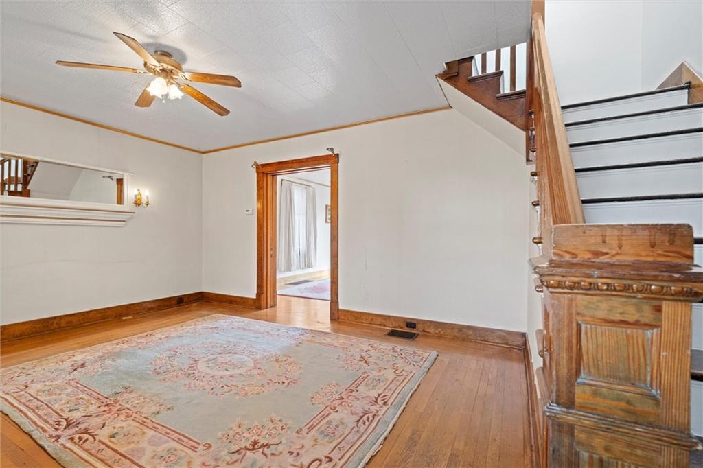 180 Center Street Springdale, PA 15144 - Photo 4 of 30 wooden floor in an empty room with a window