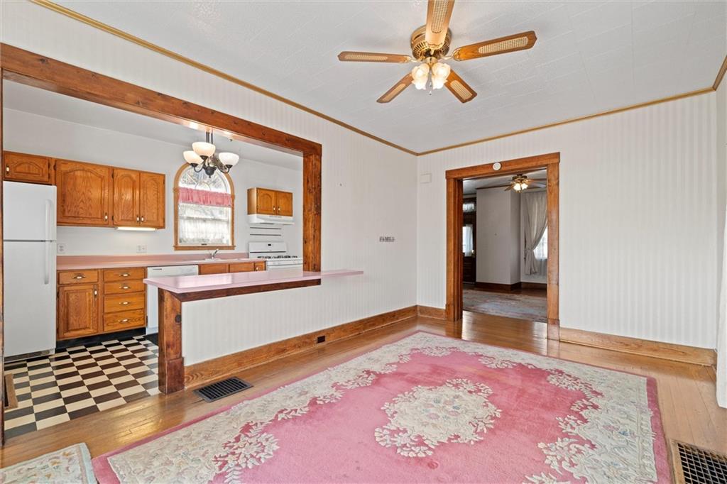 180 Center Street Springdale, PA 15144 - Photo 7 of 30 a bedroom with a bed and a chandelier