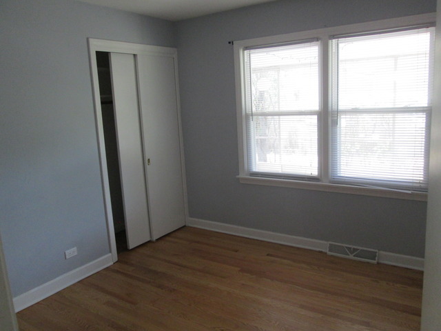 642 Wesley Drive Park Ridge, IL 60068 - Photo 7 of 11 an empty room with wooden floor and windows