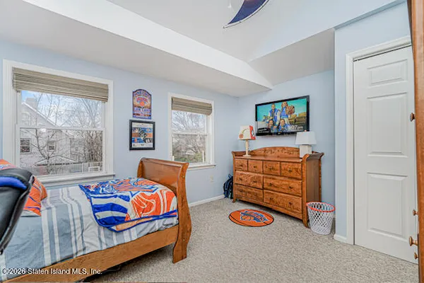 a bedroom with furniture and a flat screen tv