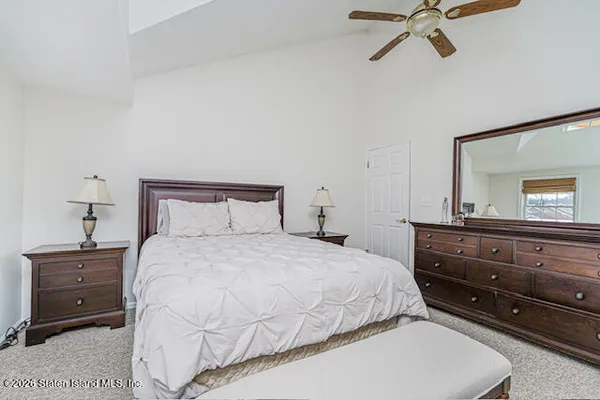 a bedroom with a bed and a mirror
