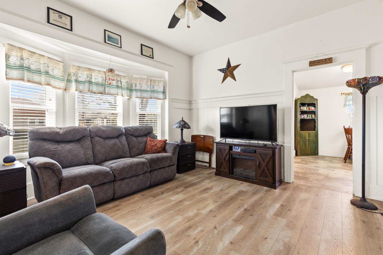 490 Hazel Street Gridley, CA 95948 - Photo 4 of 28 a living room with furniture a flat screen tv and a large window