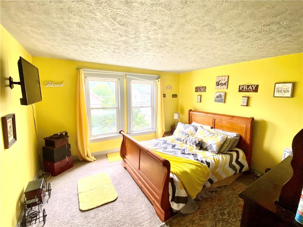 3967 Stiffler Hill Road Cherry Tree, PA 15724 - Photo 8 of 18 a bed sitting in a bedroom next to a window