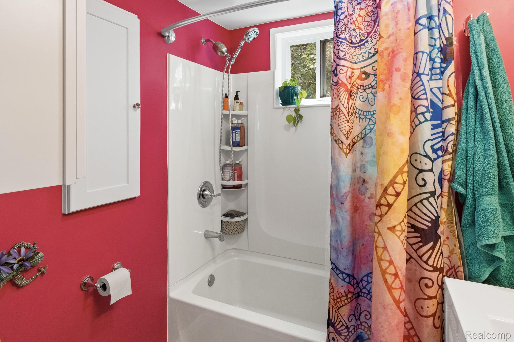 7330 Embury Road Grand Blanc, MI 48439 - Photo 20 of 29 White tub and shower combination with chrome fixtures and an integrated corner shelving unit