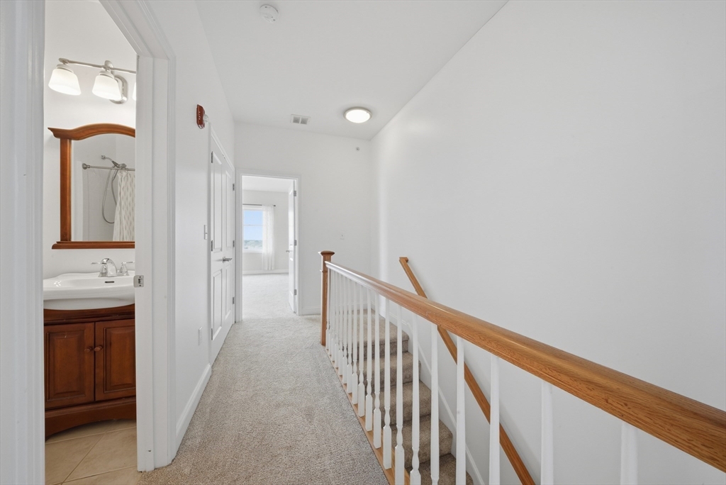 233 Beach Road, Unit A11 Salisbury, MA 01952 - Photo 15 of 37 a view of a hallway with wooden floor and staircase