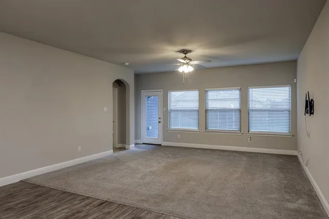 a kitchen with kitchen island granite countertop a sink stove and refrigerator