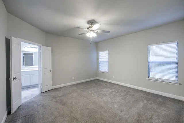 a view of an empty room with a kitchen