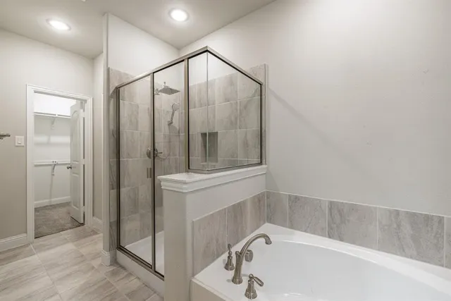 a bathroom with a tub sink and mirror