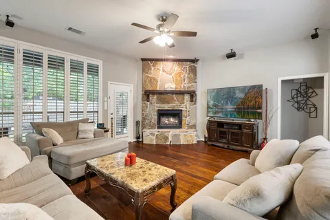 a living room with furniture fireplace and a large window