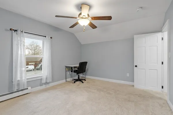 a workspace with a chandelier fan and a window