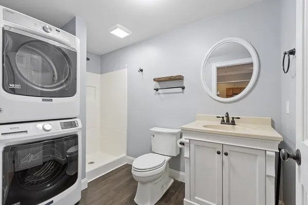 a bathroom with a sink a toilet and a mirror