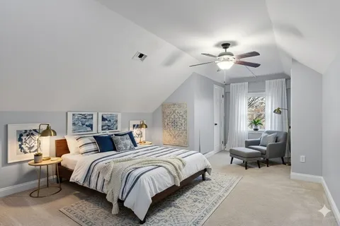 a spacious bedroom with a bed and a chandelier