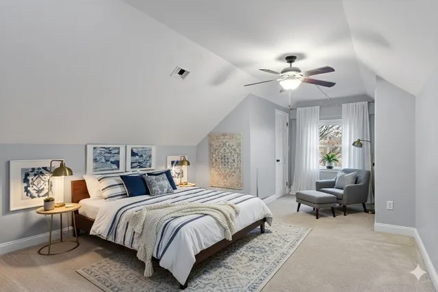 a spacious bedroom with a bed and a chandelier